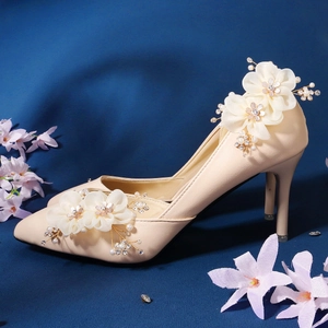 Elegant beige high heels with pearled floral ornaments and sparkling rhinestones