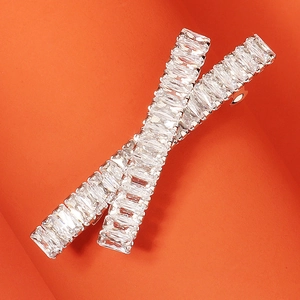 Elegant silver baguette-cut zircon hair clips set on a vibrant orange background