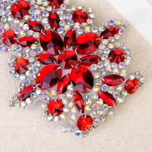 Detail of red faceted crystal bridal applique with colorful rhinestones on mesh backing