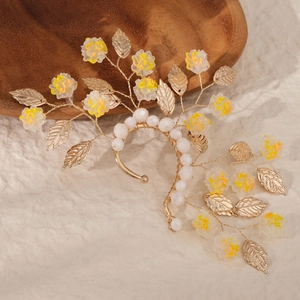 Detail showing handmade golden leaf and pearl bridal ear wrap with crystal accents
