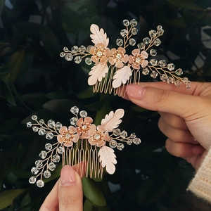 Detail of pink floral bridal hair combs with pearls and crystal beads on gold wire