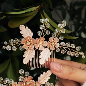 Close-up of golden bridal hair comb with crystal flowers and pearls for wedding hairstyles