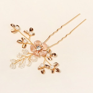 Detail of handmade gold bridal hair comb with pink flower, pearls and crystals