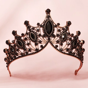 Close-up of vintage Baroque bridal crown with deep black gemstones and copper filigree