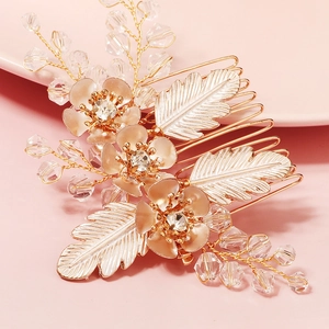 Detail of bridal hair comb with gold flowers, rhinestones and crystal beads