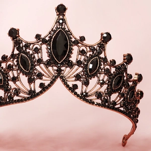 Close-up of luxury Baroque bridal crown with black rhinestones and vintage gold metal