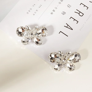 Detailed view of silver crystal butterfly shoe clips with sparkling rhinestone inlay