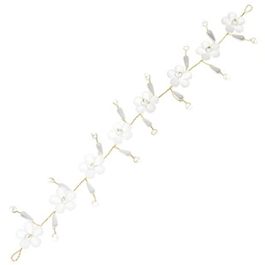 Detail of white acrylic flowers and pearls hand-woven with gold wire for bridal hair