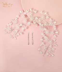 Macro shot of silver bridal hairband with acrylic pearls and crystal floral details