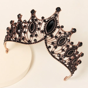 Detail of vintage baroque crown with black rhinestones and bronze hollow texture