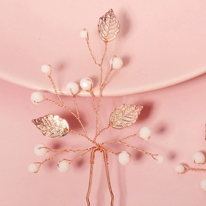 Handmade rose gold bridal hair pin with beads and metal leaves for wedding hairstyles
