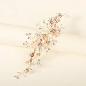 Macro view of rose gold floral hair clip with pink petals and sparkling white crystals