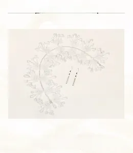 Detailed macro view of handmade bridal hairband featuring white fabric flowers and pearls