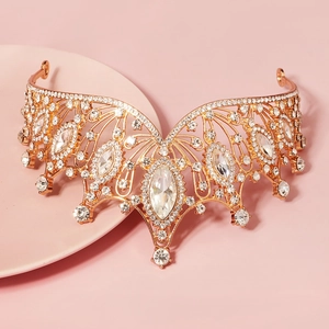 Detail of a luxury rose gold bridal crown with marquise-cut rhinestones and intricate patterns