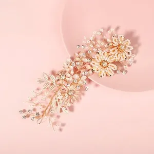 Detailed macro shot of handmade floral hair clip with rhinestones and white petals