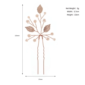 Detailed view of handmade rose gold bridal hair fork with beads and metal leaves