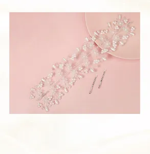 Detail of handmade bridal hairband with white pearls and crystal flower petals