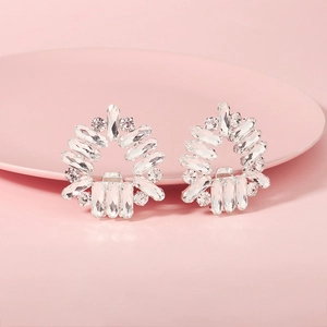 Macro detail of sparkling crystal rhinestone shoe clips on a pink decorative plate
