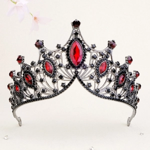Detail of Gothic Baroque crown with dark red gems and black rhinestones on metal