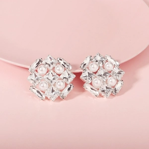 Macro shot of silver square earrings with clear crystals and four white pearls
