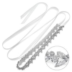 Macro detail of the hand-stitched bridal belt with vintage crystal leaf rhinestone patterns