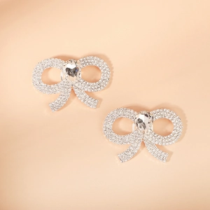 Macro view of crystal rhinestone bow shoe clips with pear-shaped center stone for bridal shoes
