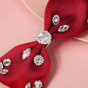 Elegant red satin bow hair clip with sparkling rhinestones in a floral crystal pattern