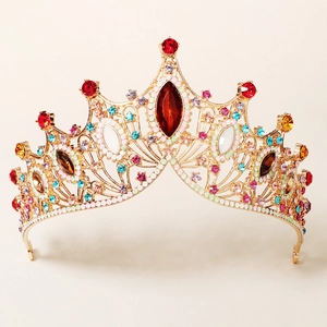 Detailed macro view of Baroque golden crown featuring a large red central gemstone