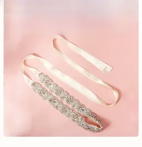 Detailed view of luxury bridal belt with sparkling rhinestones and pearls on ivory ribbon