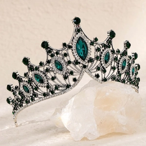 Detailed side view of Baroque crown with emerald gemstones and silver crystals