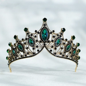 Detail of baroque crown showing emerald green crystals and black rhinestones