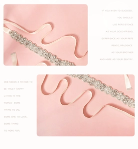 Detailed close-up of crystal bridal belt with ivory satin ribbon and floral rhinestones