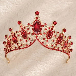 Detail of baroque crown with vintage red rhinestones and golden filigree carving