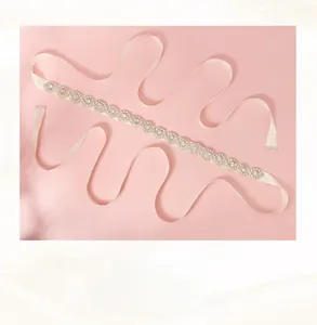 Detailed macro view of crystal wedding belt with copper wire weaving and satin ribbon
