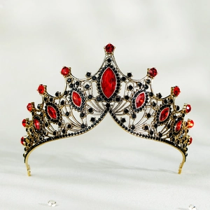 Macro detail of Baroque crown with red marquise gems and black rhinestones