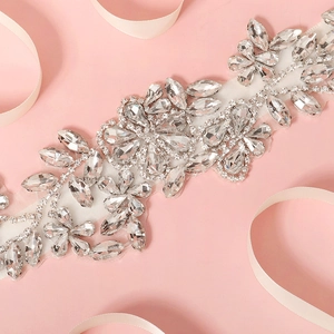 Sparkling crystal bridal sash with marquise rhinestones on a romantic pink background