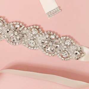 Elegant crystal rhinestone bridal belt with floral motifs on white satin ribbon