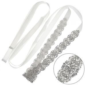 Elegant bridal belt with sparkling rhinestones and pearls on a smooth white satin ribbon