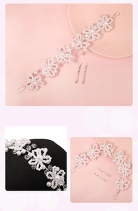 Detail of handmade bridal headband with white faux pearls and crystal flowers
