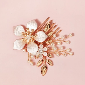 Elegant bridal hair comb with white crystal flowers and pearls on golden alloy
