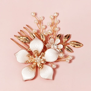 Elegant bridal hair comb featuring white flower with pearls and crystals on gold metal frame