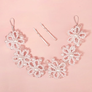 Handmade pearl and crystal floral bridal headband with hair clips on pink background