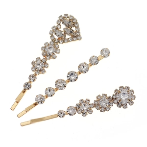 Ensemble de trois barrettes dorées avec motifs floraux en cœur et strass étincelants