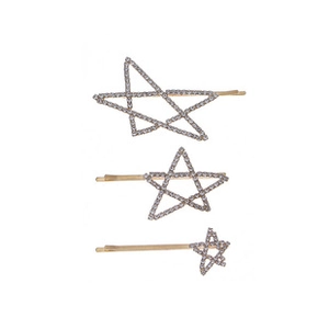 Close-up of three gold star hair clips with sparkling rhinestones in various sizes