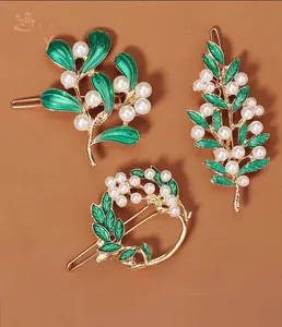 Detailansicht der Vintage-Gold-Haarnadeln mit grünem Emaille und weißen Perlen