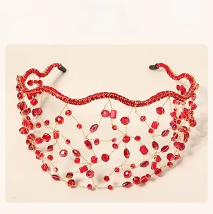 Detailed view of handcrafted red crystal beaded mesh crown headband with golden wire work