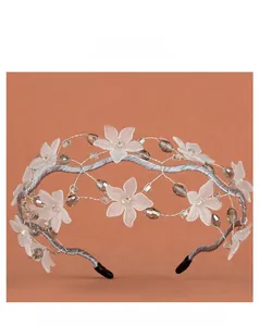 Detailed close-up of bridal headband with frosted flowers and grey crystal beads