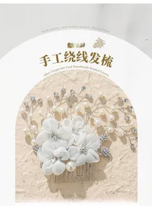 Detailed macro of handmade bridal hair comb with pearls, rhinestones and gauze flowers