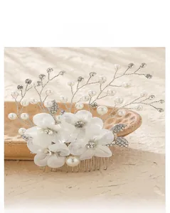 Detailed view of handmade bridal hair comb with fabric flowers, pearls, and rhinestones