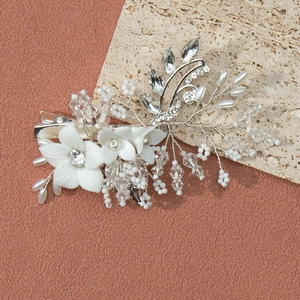 Detailed view of handmade bridal hair clip with white resin flowers and pearls